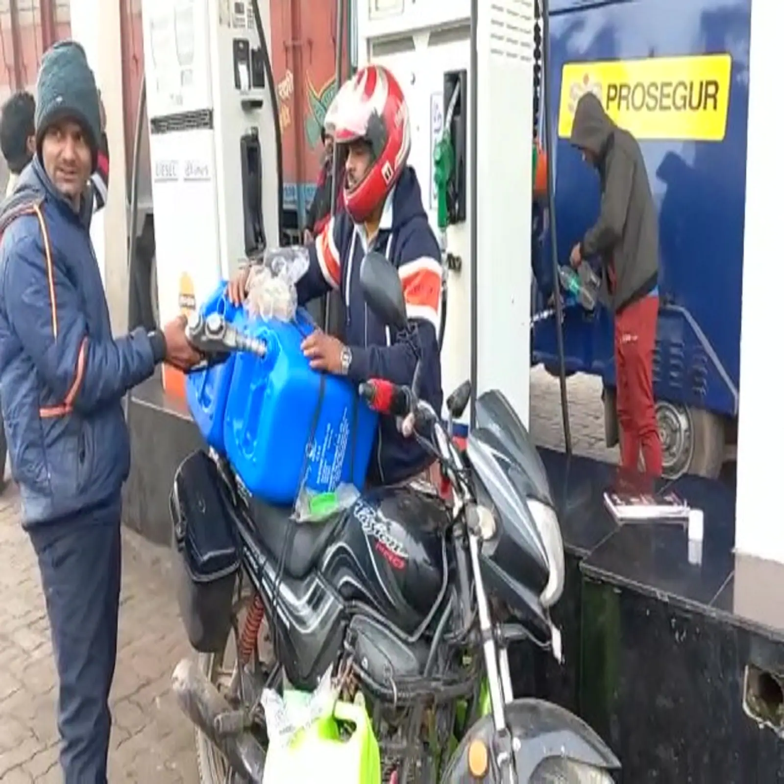 A customer from Bihar takes oil at a petrol pump in Uttar Pradesh