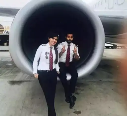 Pilot Monica Khanna with her partner near the plane