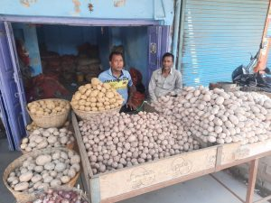 Madan Sao sells potatoes and onions on the sidewalk