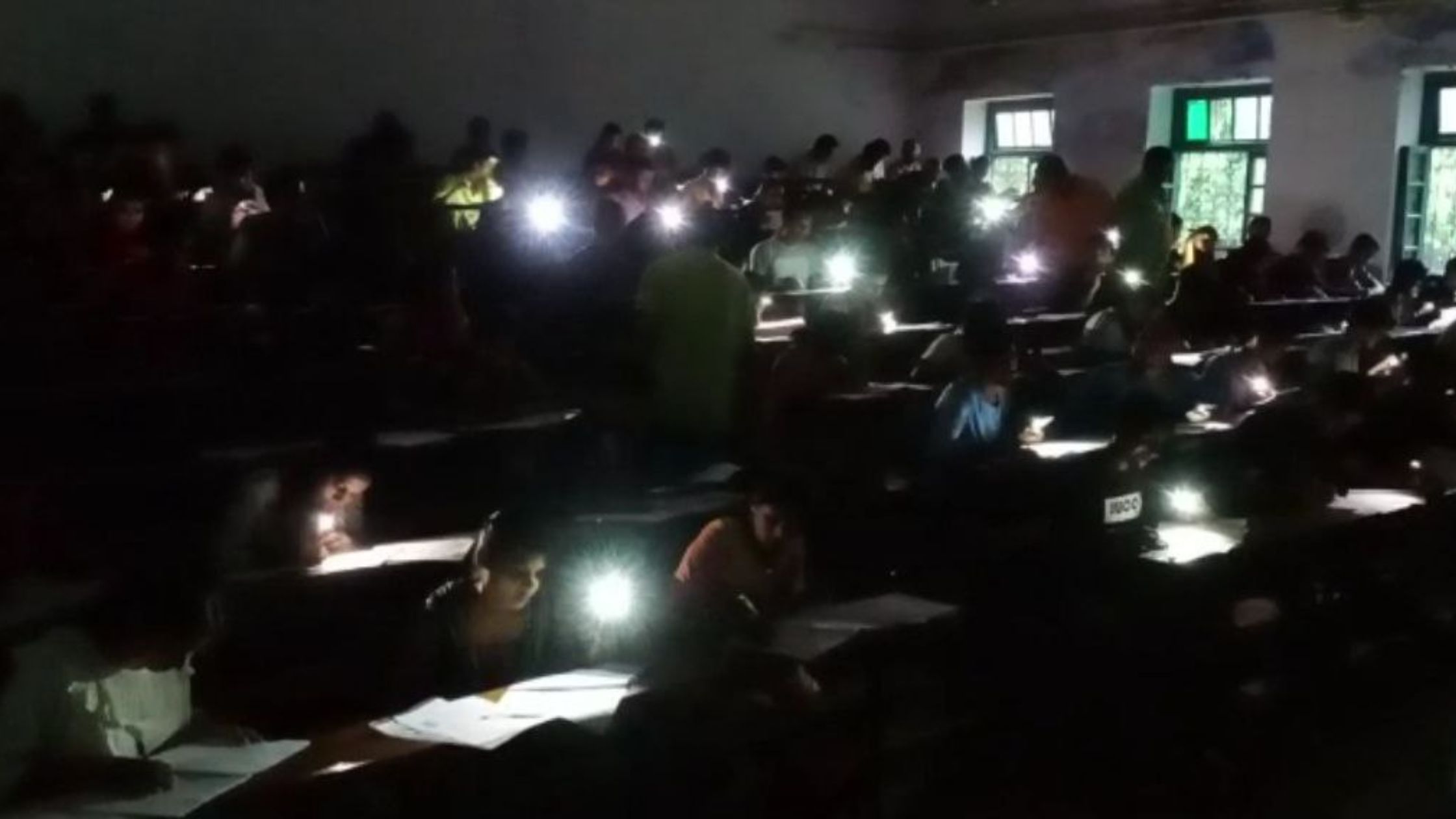 students using mobile flash light in examination of graduation in bihar